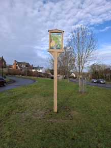Public Art sign showing historical buildings  water pump  canal and windmill.