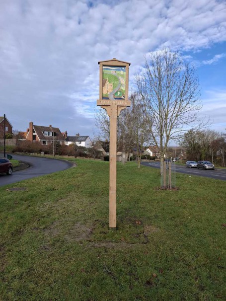 Public Art sign showing historical buildings  water pump  canal and windmill.