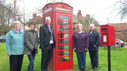 Councillors celebrating the installation of the defibrillator in the old phone box on the Village Green.